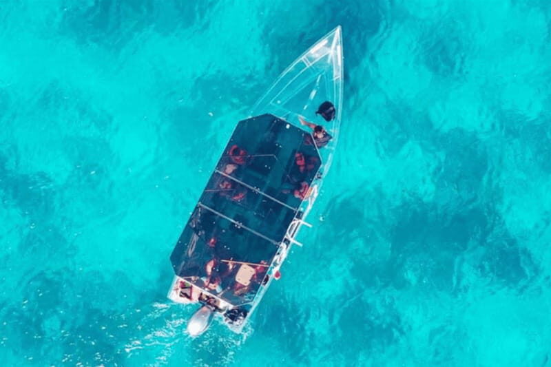 Explore the sea of cozumel in a transprent boat with drinks and snorkel. - Real Traveler Insights