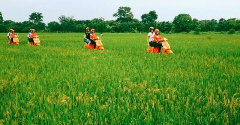 Red River delta & rural village with female Ao dai riders - The Sum Up